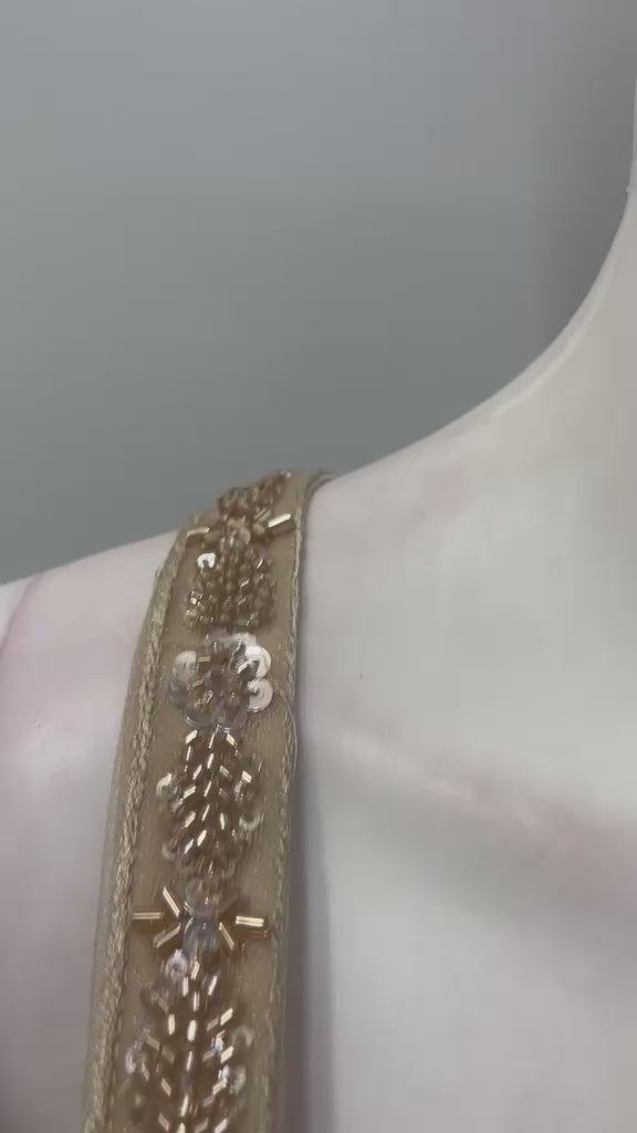 Champagne taupe crystal draped skirt set shown in movement on the model