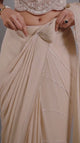 Champagne pearl draped saree set shown in movement on the model