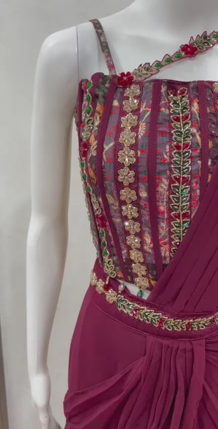Wine embroidered draped saree shown in movement on the model