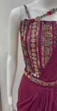 Wine embroidered draped saree shown in movement on the model