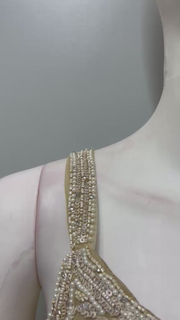 Champagne pearl draped saree set filmed from the front and side