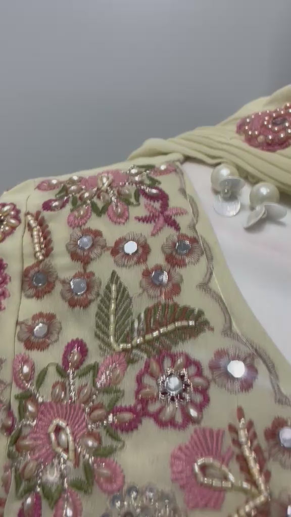 Ivory blush peplum palazzo ensemble shown in movement on model