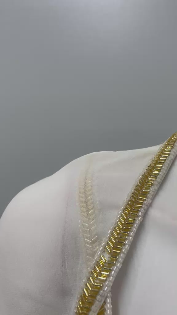 Ivory modern drape saree with gold blouse shown in movement on the model