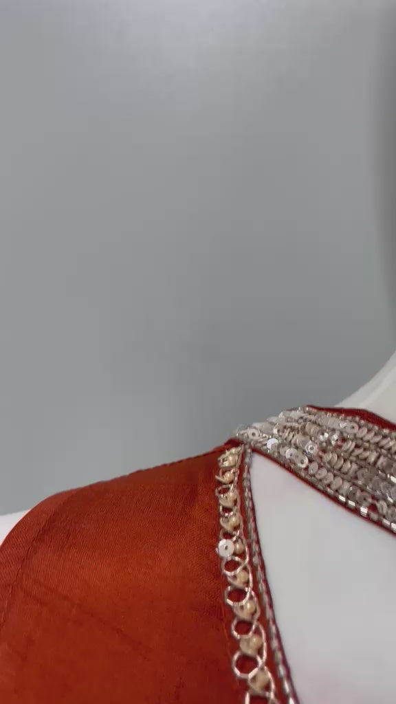 Burnt orange gold embroidered palazzo shown in movement on the model