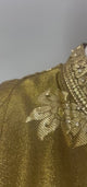 Antique olive gold botanical lehenga ensemble shown in movement