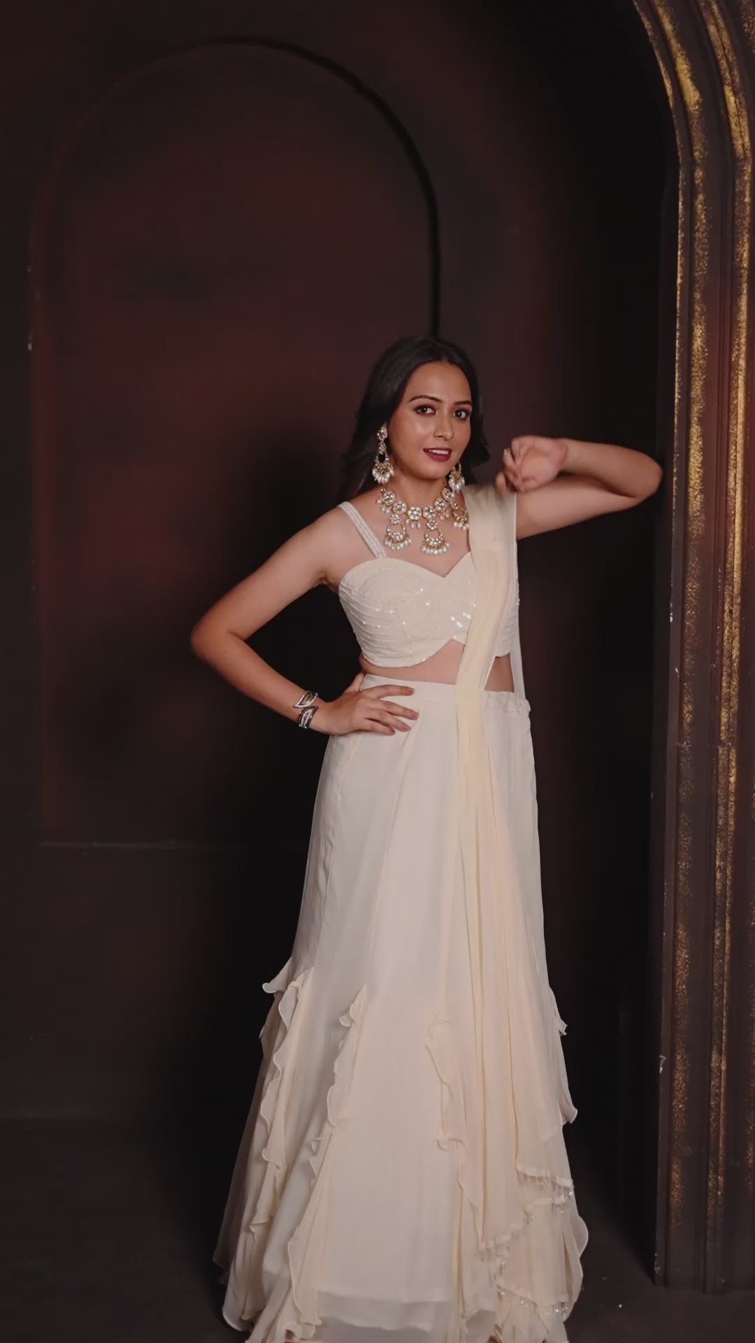 Ivory Ruffle Layered Georgette Lehenga Set with Embroidered Sheer Cape & Draped Corset Blouse – Minimalist Luxe Couture