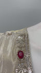 Ivory and gold sharara suit set shown in movement on the model