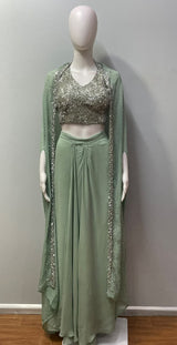 Mint green draped skirt with an embellished bustier and sheer cape