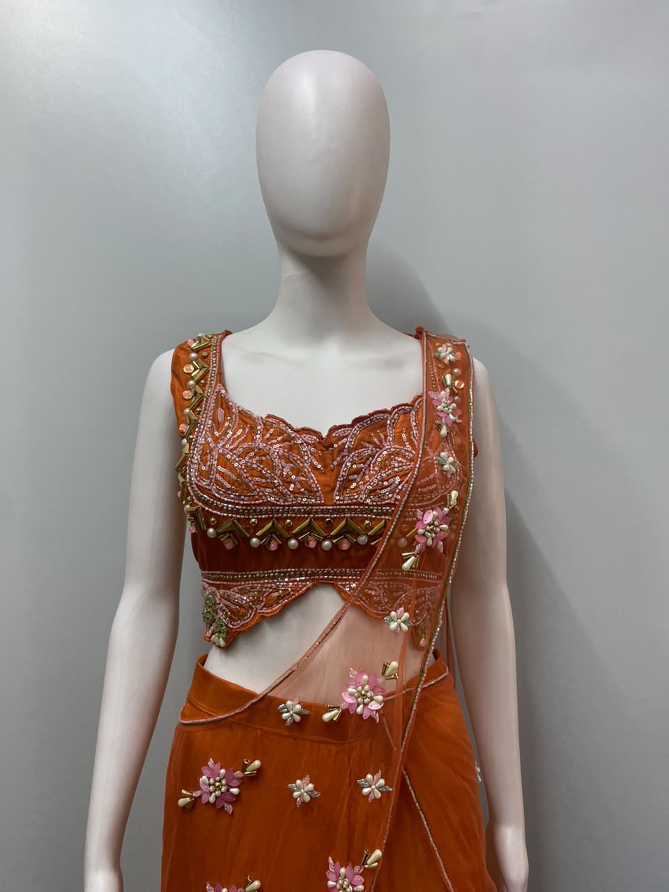 Burnt orange palazzo set photographed against a plain backdrop