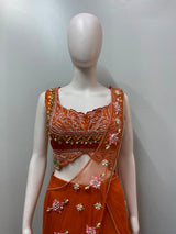Burnt orange palazzo set photographed against a plain backdrop